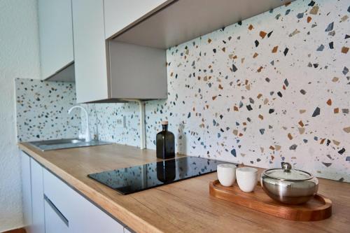 a kitchen with a counter with a bottle of wine at Best Apartments on Kyryla & Mefodia in Mukacheve