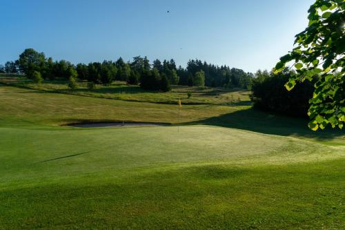a view of a golf course with a green at Penzion Golf Luby 