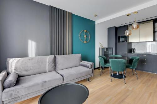 a living room with a couch and a table at GRANO APARTMENTS Gdańsk Old Town SPA & Wellness - GRANO APARTMENTS Gdańsk Residence SPA & Wellness in Gdańsk