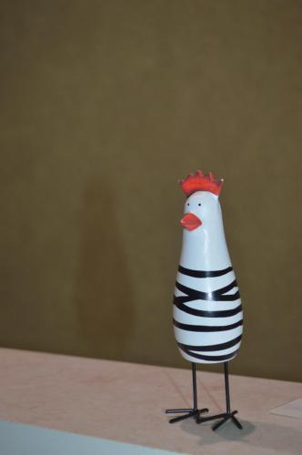 a toy chicken is standing on a table at Дбайлива Ципа in Mizhhirʼʼya