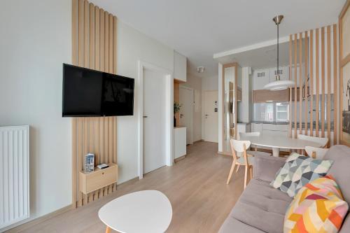 a living room with a couch and a table at GRANO APARTMENTS Gdańsk Old Town SPA & Wellness - GRANO APARTMENTS Gdańsk Residence SPA & Wellness in Gdańsk