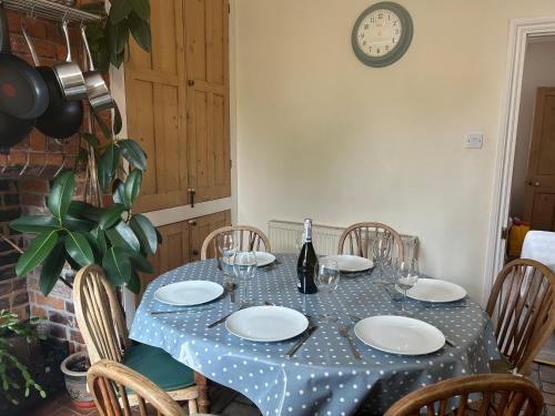 a table with a blue and white polka dot table cloth at Seagulls Cottage in the heart of Exmouth in Exmouth