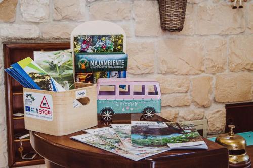 a table with a box and a toy bus on it at Hotel B&B Pescofalcone in Caramanico Terme