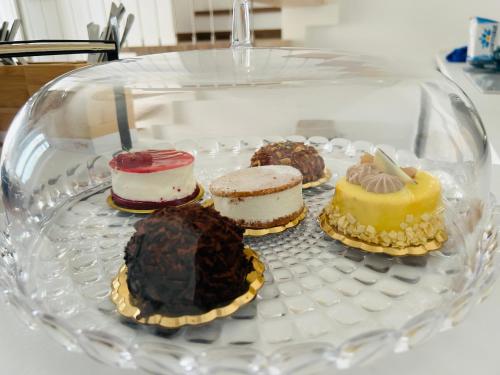 a glass plate with different types of cakes on it at B&B Dimora Santucci in Rodi Garganico