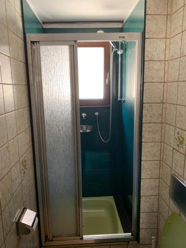 a bathroom with a shower with a tub and a sink at Gasthaus Waldhorn in Bad Teinach-Zavelstein