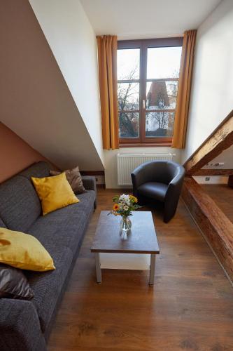 a living room with a couch and a table at Residence Mariánská in České Budějovice