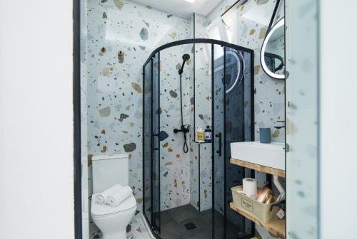 a bathroom with a rock wall at Anais Luxury Living Grey & Pink by CorfuEscapes in Marathias