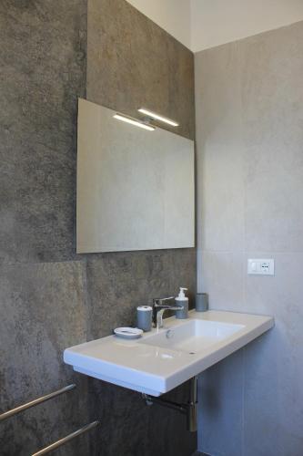 a bathroom with a white sink and a mirror at Like Lake Martana in Marta