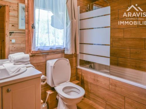 a bathroom with a toilet and a sink at Chalet Le Grand-Bornand, 8 pièces, 16 personnes - FR-1-391-33 in Le Grand-Bornand