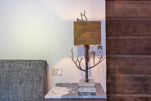 a lamp sitting on a table next to a couch at Frantoio Del Moscatello in Camaiore