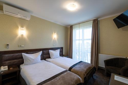 Postel nebo postele na pokoji v ubytování Avalon Palace