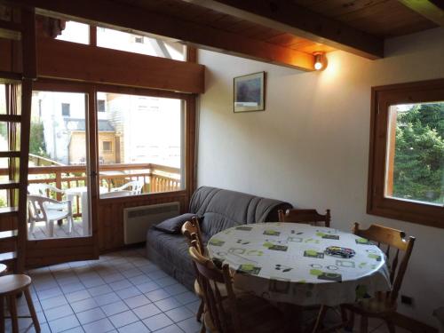 un salon avec une table et un canapé dans l'établissement Appartement cosy 6 pers à 300m des pistes avec garage et mezzanine - Crest-Voland - FR-1-595-80, à Crest-Voland