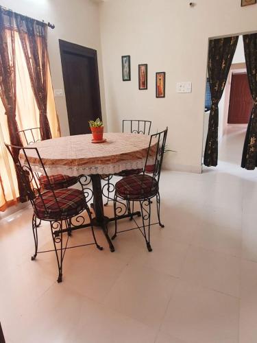a table and chairs in a living room at Mimo's in Guwahati