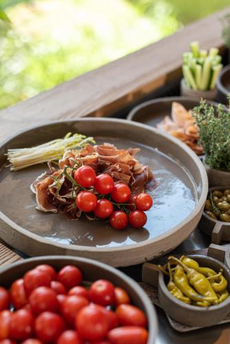a plate of tomatoes and other vegetables on a table at Pilot Amphora Boutique Hotel "Adults Only" in Georgioupolis