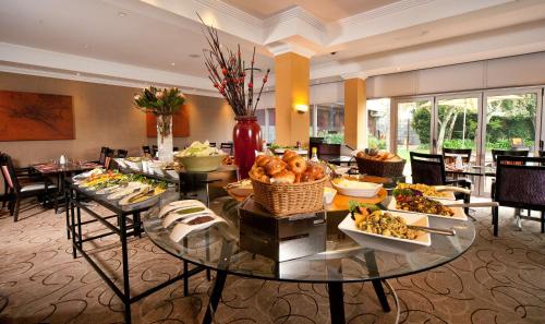 a buffet of food on a table in a hotel room at Southern Sun OR Tambo International Airport in Kempton Park