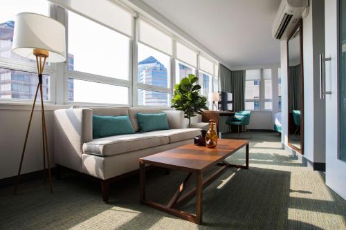 a living room with a couch and a table at Unscripted Durham, Part of JDV by Hyatt in Durham