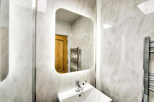 a bathroom with a sink and a mirror at Onich Hotel & Lochside Beach Pods in Onich