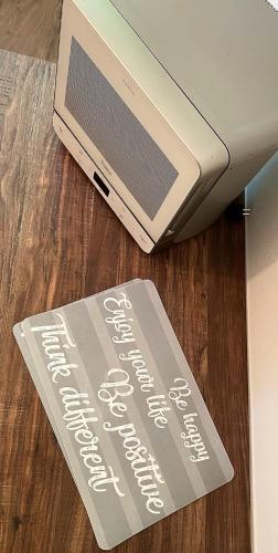 a sign sitting on the floor next to a laptop at SleepWell in Valganna in Valganna