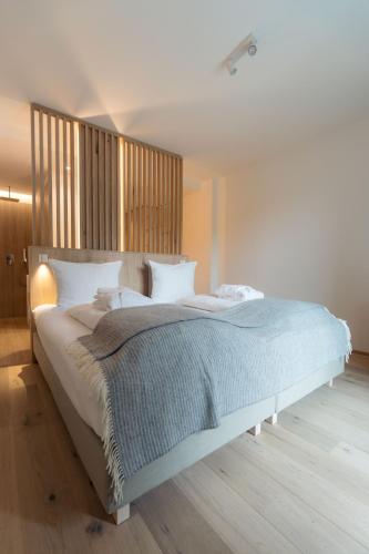 a bedroom with a large bed with a wooden headboard at Anett hotel in Vipiteno