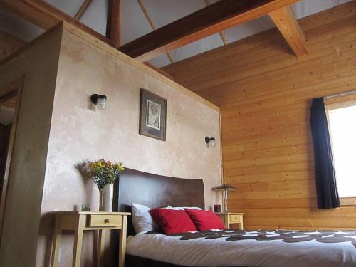 a bedroom with a bed with red pillows at Towerhouse - Modern Cabin @ 8,000ft in Wanship