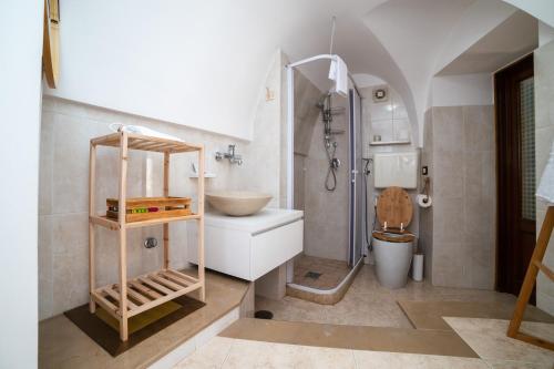 a bathroom with a sink and a toilet at Casa GianAngel Ostuni in Ostuni