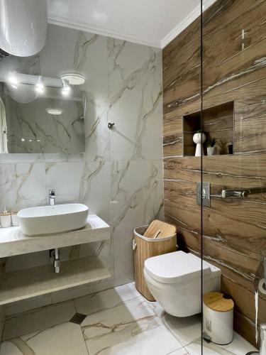 a bathroom with a sink and a toilet at VALENCIA GARDENS ROYAL in Nesebar