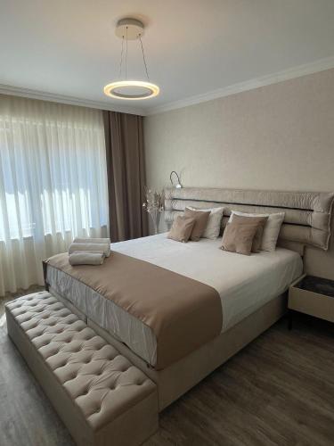 a bedroom with a large bed and a large window at VALENCIA GARDENS ROYAL in Nesebar