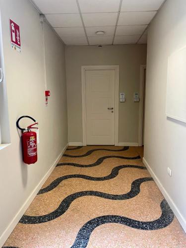 a hallway with a snake carpet on the floor at Hotel Bazzoni in Tremezzo