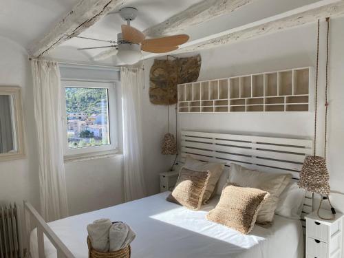 Alfara de CarlesにあるCasa Rural Parc Natural dels Portsのベッドルーム1室(白いベッド1台、天井ファン付)