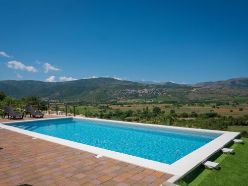 a swimming pool with a view of the mountains at AgriRelais San Giovanni in Capestrano