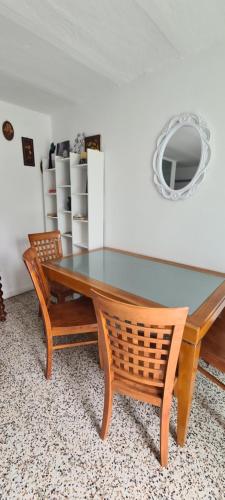 a dining room table with two chairs and a mirror at Da Ersilia in Cernobbio