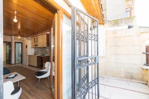 a pivot door opens up to a balcony with a table and chairs at Taksim full House in Istanbul