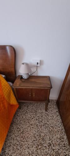 a lamp on a night stand next to a bed at Da Ersilia in Cernobbio