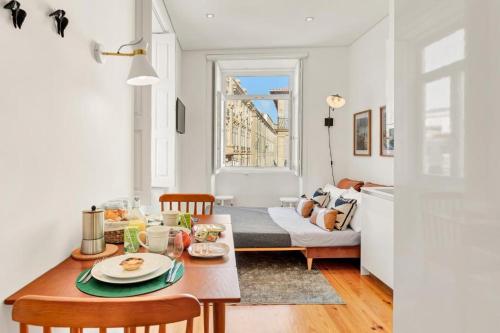 a living room with a table and a couch at Host Wise - Lovely Shinny Flats with Balcony - Clerigos in Porto