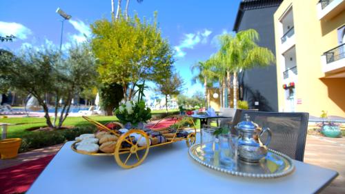 a table with a tray of food on top of it at El Olivar Palace Marrakech All Inclusive, Aquapark & SPA in Marrakech