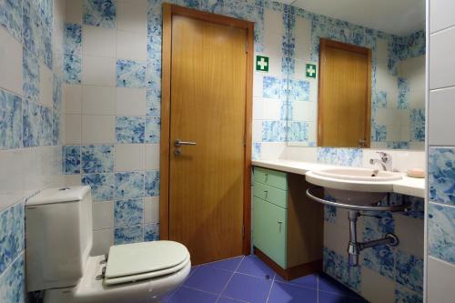a bathroom with a toilet and a sink at O búzio in Albufeira