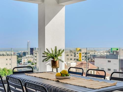 a dining room table with a view of a city at Sanders Elgio in Limassol