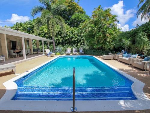 a swimming pool in the backyard of a house at Amazing Villa with Pool 5 mins from Beach - Palm Grove 1 home in Saint Peter