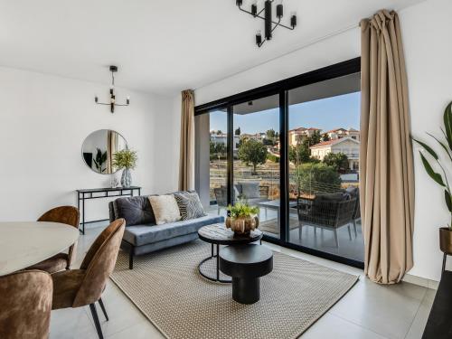 a living room with a couch and a table at Sanders Elgio in Limassol