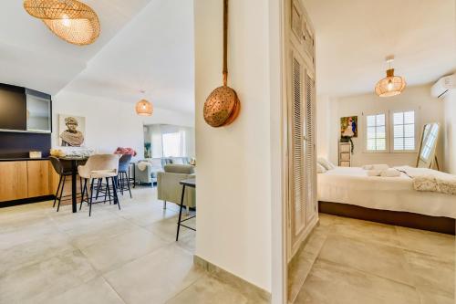 a bedroom with a bed and a dining room at Luxury Apartment Seaside Bay in Moraira