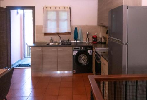 a kitchen with a refrigerator and a sink and a dishwasher at #On The Rocks in Ouranoupoli