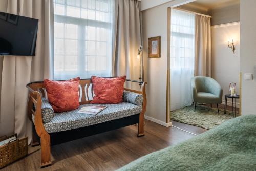 a hotel room with a couch and a window at Hotel Würzburger Hof **** in Würzburg