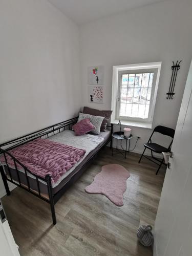 a bedroom with a bed and a chair and a window at Belavita in Bovec