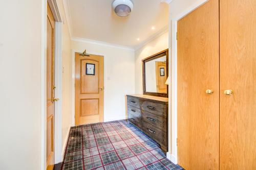 a bathroom with a dresser and a mirror at Onich Hotel & Lochside Beach Pods in Onich
