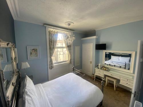 a bedroom with a white bed and a window at Blue Sky Guest House in Brighton & Hove