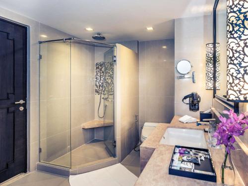 a bathroom with a shower and a sink at Mercure Bangkok Sukhumvit 11 in Bangkok