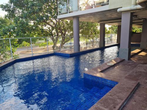 a swimming pool in the middle of a building at Dashwood Dreaming - Room in Shared Apartment in Darwin