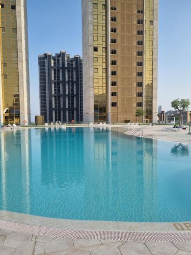 a large swimming pool in front of some tall buildings at Floor 32! INTEMPO Luxury in Benidorm