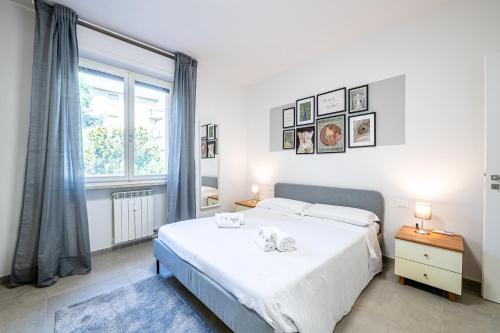 a bedroom with a bed and a large window at Homiday - New House - Pisa Aeroporto - Free Parking in Pisa
