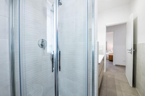 a glass shower in a bathroom with a sink at Homiday - New House - Pisa Aeroporto - Free Parking in Pisa